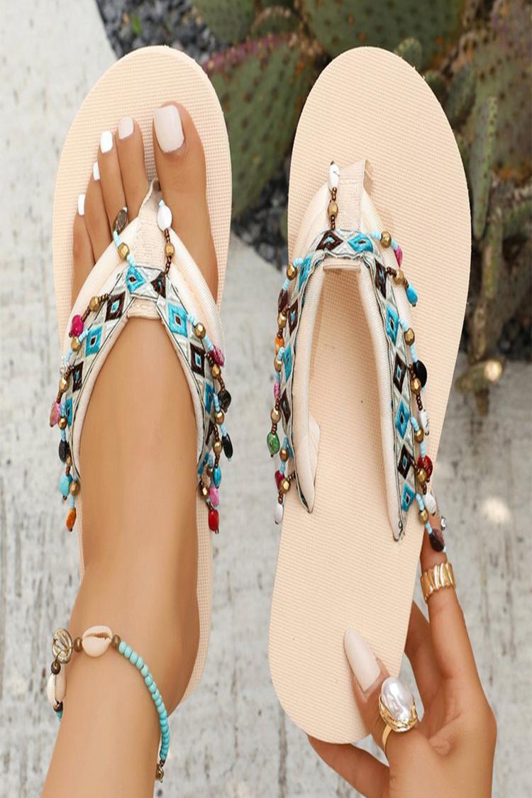 Ciabatte casual con motivo geometrico in stile etnico e nappe decorative