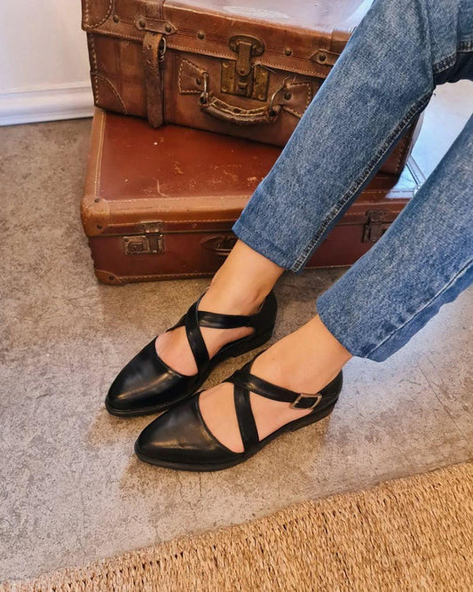 Schwarze glänzende Schuhe mit Kreuzriemen und niedrigem Absatz